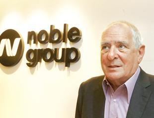 Noble sells oil-liquids business, warns of loss