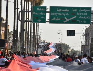 Iraq paramilitaries battle Kurds in push towards Turkish border oil hub