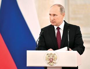 Putin takes part in army drills, fires missiles