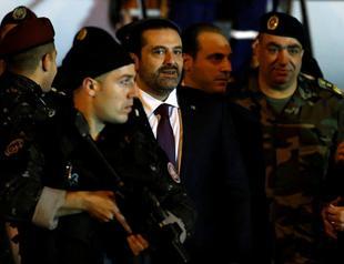 Hariri back in Beirut, shelves resignation