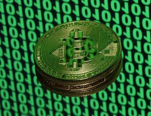 Bitcoin tops $18,000 in debut on major bourse