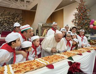 Pope Francis blows out birthday candle on extra-long pizza