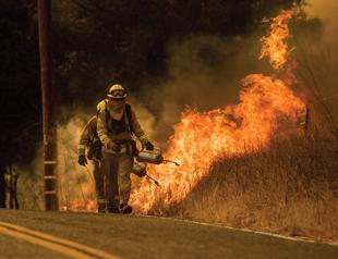 Break in winds helps California battle historic wildfire