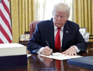 Trump signs tax, government spending bills into law