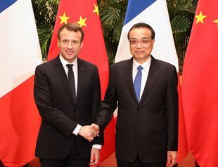 France signs deals with China but warns against ‘pillaging’