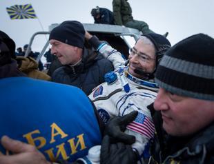 Three space station astronauts return to Earth