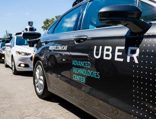 Uber suspends self-driving car tests after pedestrian death