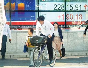 Asian markets lower after hawkish Fed, fresh trade war fears