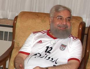 Iran President Rouhani cheers World Cup win wearing team jersey
