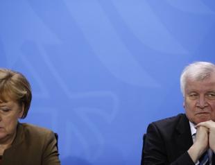German interior minister says dispute with Merkel is history