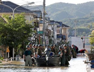 Rescuers race to find survivors after Japan floods kill at least 112