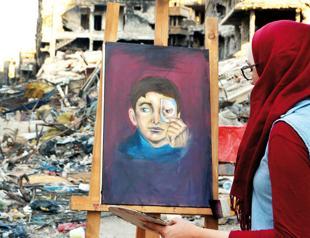 In Syria’s Yarmuk, artists paint amid the ruins