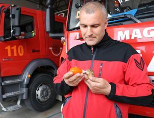Firefighter takes care of baby squirrel