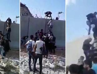 Footage shows Syrians scaling Turkish border wall with ladders