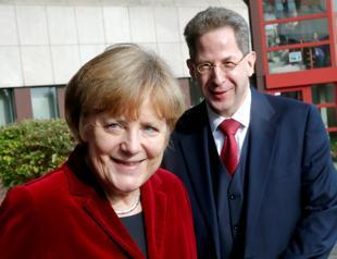 Merkel removes spy chief to defuse row over far-right
