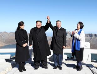 Kim, Moon join hands on peak of sacred North Korean volcano