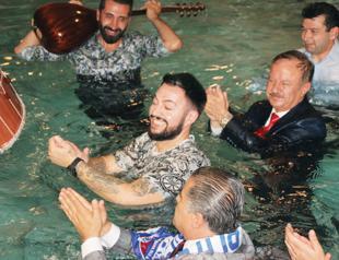 Turkish mayor goes into hot springs pool wearing suit
