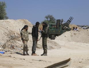 Rebels fire shells from Syria buffer despite heavy arms pullout