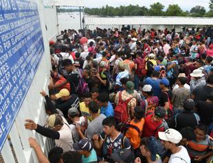Mexico allows caravan women, children in, but thousands still stranded