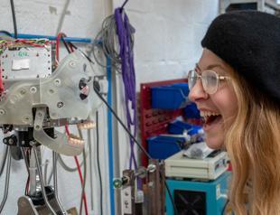 Ai-Da the robot artist draws sketches of people