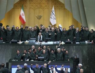 Iranian lawmakers convene in military uniforms