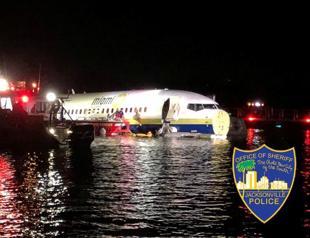 Boeing 737 slides off runway into Florida River