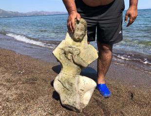 Marble sculpture depicts woman breastfeeding lion cub