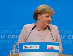 Merkel vows coalition will push on despite jitters as SPD chief quits