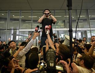 Pressure builds on Hong Kong leader as activist vows to join protests