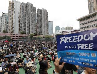 Hong Kong protesters stream past designated endpoint