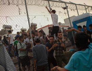 Migrants in Greece set fires at camp; at least 1 killed