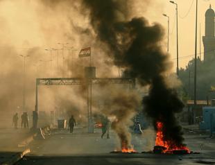 Iraq blames malicious hands as toll from unrest tops 100