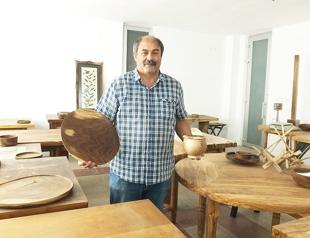 Engineer crafts wasted olive tree branches