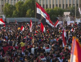 Iraqis defy crackdown to hold biggest protests yet