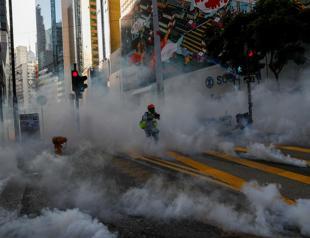 Hong Kong chaos sees tear gas, attack on Chinese news agency