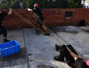 Hong Kong protesters shoot arrows, hurl petrol bombs in campus clash