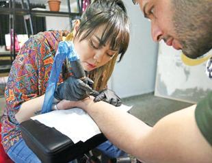 A tattoo at a time, Afghan woman takes on taboos