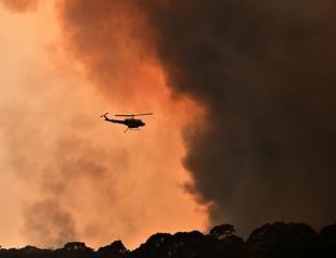 Australian PM apologises for vacation as firefighters killed in huge blazes