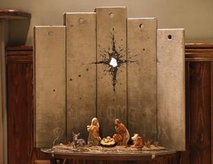 Mysterious artist Banksy unveils dark nativity in Bethlehem