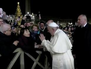 Disgruntled Pope Francis pulls himself free from womans grasp