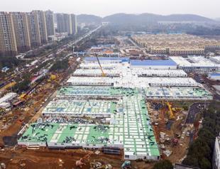 China opens virus hospital, market plunges as toll grows