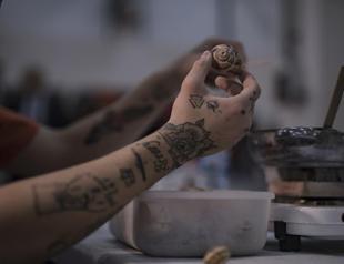 Inmates prepare snail shells for European dishes