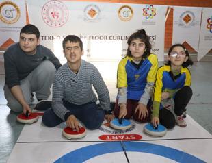 Visually impaired students play curling using motion sensors