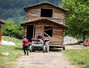 House moved by truck to keep deceased owner’s memory alive