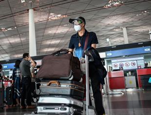 Beijing cuts flights to curb potential spread of mounting coronavirus cases