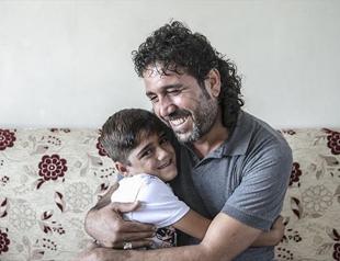 Father, son reunite at Syrian border crossing