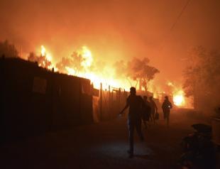 Thousands flee fire at migrant camp on virus lockdown in Greece