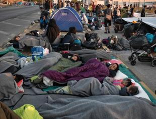 Thousands spend third night in the open after Greek migrant camp fire