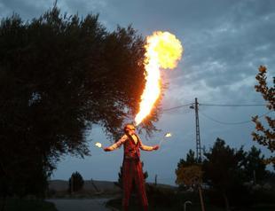 Courier man entertains people wearing 3.4-meter-high wooden stilts