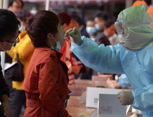 China tests entire city for virus as WHO slams herd immunity idea